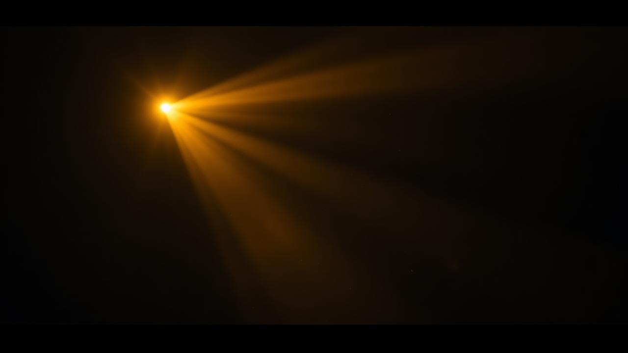 A single beam of gold projector light cutting through a dark cinema